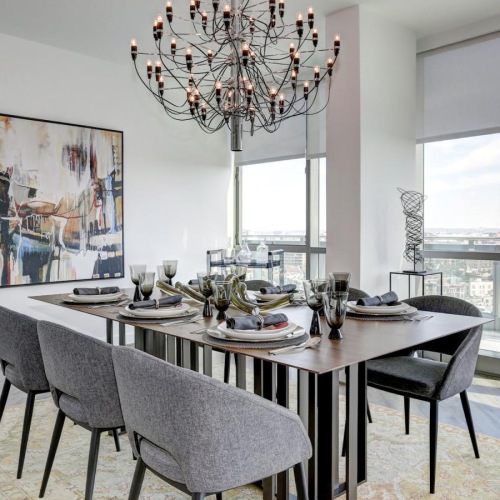 a dining room table with chairs and a chandelier above it