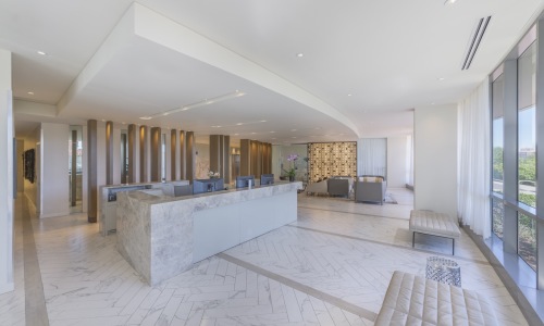 the lobby of a building with a desk and computers