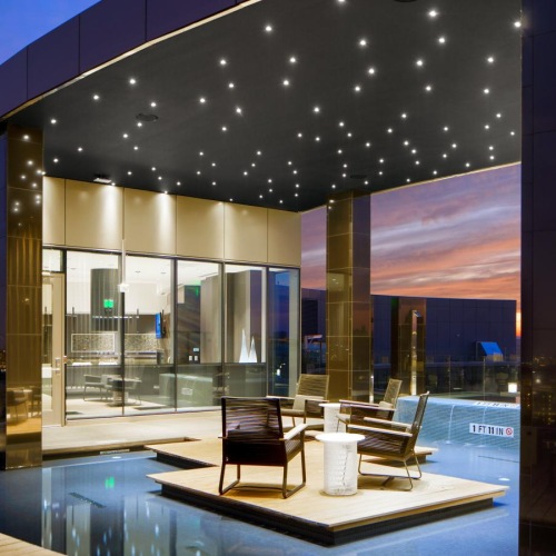 a pool with a large glass wall